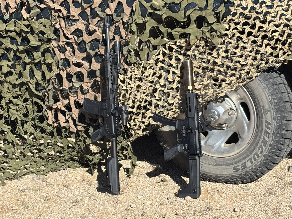 cmp9 and cmp9k leaning on a truck